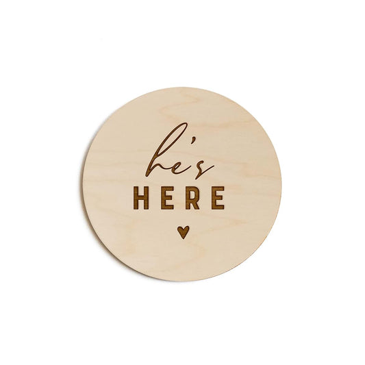 The Cotton & Canvas Co. He's Here Newborn Baby Announcement Wooden Disc